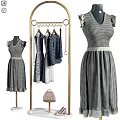Checkered Dresses Hanging On Gold Clothes Rack With Mannequin And Handbag