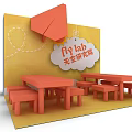 Orange Paper Airplane Themed Fly Lab Space With Tables Benches And Yellow Background