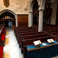 Cartoon Church Interior Scene Featuring Wooden Pews Columns Arched Doorway Open Books And Blue Tablecloth