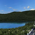 Picturesque Natural Scenery With Blue Lake Lush Green Mountains And Suspension Bridge Under Clear Sky