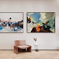 Abstract Paintings On Wall With Brown Chair Small Table And Green Plant