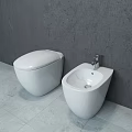 Sleek Modern White Toilet In Bathroom With Gray Walls And Light Colored Floor