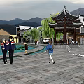 Ancient Architecture Pavilion With Lotus Pond Weeping Willows And Mountain View