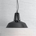 Black Metal Industrial Pendant Light Hanging Over White Brick Wall Interior