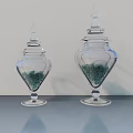 Transparent Ceramic Vessels With Lids Containing Green Granules On Smooth Surface