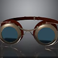 Vintage Brass Frame Goggles With Red Headband And Blue Lenses On Black Surface