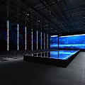 Spacious Indoor Venue With Rows of Chairs Large LED Screen and Central Platform