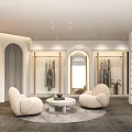 Modern Clothing Store Interior With Display Racks Sofas And Round Coffee Table