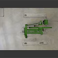 Green Mechanical Equipment with Large Circular Wheel and Metal Frame on Gray Platform