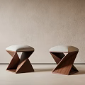 Geometric Wooden Stools With Light Upholstered Seats Against Beige Wall And Light Floor