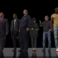 Group of Diverse People Standing Against Black Background With Varied Clothing Styles