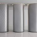 Modern Silver Metallic Columns With Twisted Lines And Perforated Pattern In Minimalist Interior Setting