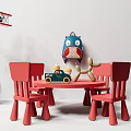 Red Kids Table With Two Chairs And Colorful Toys In Playroom