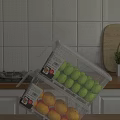Transparent Plastic Storage Container With Green Balls And Yellow Fruits In Kitchen