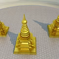 Three Golden Multi Tiered Pagodas With Spired Tops On Paved Ground 3d model