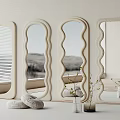 Decorative Mirrors with Wavy Textured Frames Against Light Wall and Beige Cushions with Potted Plants