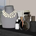 Luxury Pearl Necklace Display on Gray Mannequin With Stylish Perfume Bottles for Elegant Jewelry Showcase
