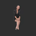 Woman in Black Suit Dress With Hands Folded on Knees Smiling Against Black Background