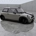Small Silver Gray Car with Black Roof and Black Wheels in Spacious Modern Indoor Space