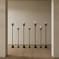 Multiple Black Candle Lamps With White Candles In Indoor Scene Wooden Floor Beige Walls