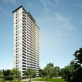 High Rise Residential Building With Green Surroundings Road Access Parking Spaces and Urban Landscape View