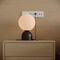 Beige Round Lampshade Table Lamp With Black Base On Wooden Nightstand