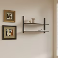 Light Wall Corner With Framed Abstract Paintings And Black Shelf Holding White Vase And Books