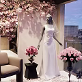 Elegant Wedding Dress Clothing Store With Pink Flowers And Mannequin