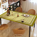 Elegant Dining Table Set With Green White Checkered Tablecloth Rattan Chairs And Decorative Tableware