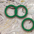 Three Elegant Green Rings Fashion Jewelry With Smooth Surface On Marble Background