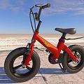 Red Balance Bike With Large Wheels Black Seat And Yellow Accents In Outdoor Field