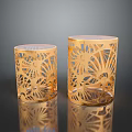 Two Golden Decorative Candle Holders With Intricate Laser Cut Patterns On Black Surface 3d model