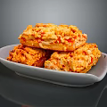 Crunchy Golden Baked Snacks With Granular Surface Stacked On White Plate