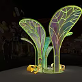 Colorful Leaf Shaped Glowing Light Installation With Yellow Stones And Grass