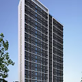 High Rise Modern Residential Building with Many Windows Trees Nearby and Blue Sky Background