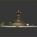Garden Ornament Circular Tiered Fountain Surrounded by Small Plants and Stone Borders