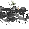 Outdoor Black Rattan Table And Chairs Set With Plant And Candle Holder Decor