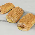 Golden Baked Sandwiches with Striped Crust and Cheese Ham Filling on Marble Countertop