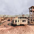 Arid Desert Landscape With Watchtower Simple Buildings Fence And Distant Mountains