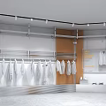 Modern Bright Clothing Store Interior With Hanging White Apparel And Metal Racks