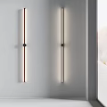 Modern Wall Sconces With Slim Black Metal Frames And Soft Illumination On White Interior Wall