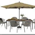 Modern Outdoor Table with Chairs and Umbrella Featuring Vase and Fruits on Top
