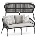 Elegant Wicker Two Seater Sofa With Black Frame Gray Cushions And Patterned Pillows
