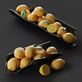 Fresh Lemons Displayed in Black Trays with Sliced Lemons and Green Leaves