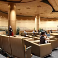 Modern Conference Room Interior With Brown Seats Wooden Ceiling And People Inside