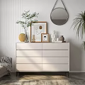 White Dresser Topped With Vase Photo Frame Sculpture Mirror And Green Plants In Light Room