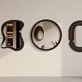 Modern Decorative Mirrors in Various Shapes with Black Frames Hanging on Beige Wall