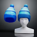 Blue Striped Knit Hat With Pom Pom Displayed On Mannequin Head