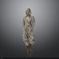 Blonde Woman in Beige Jumpsuit with Knee High Boots Standing Against Gray Background