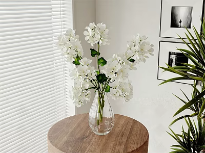 White Flowers With Green Leaves In Glass Vase On Wooden Round Table 3d model